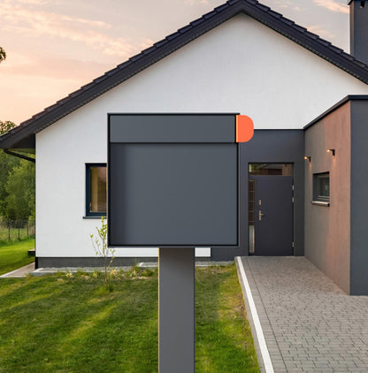 Post mount mailbox TOWN SQUARE in anthracite gray color outside a modern house with a stylish design.