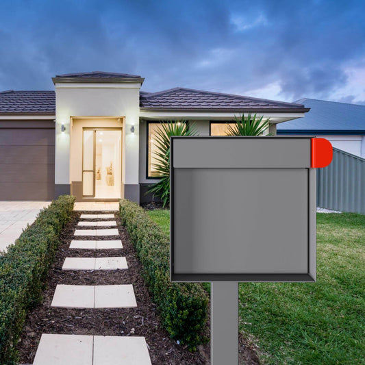 Stylish residential mailbox in gray located at a modern home with a well-manicured garden.