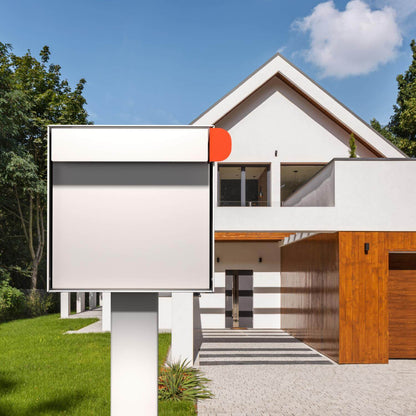 Post mount mailbox TOWN SQUARE with a modern design in white and orange, set in front of a contemporary house.